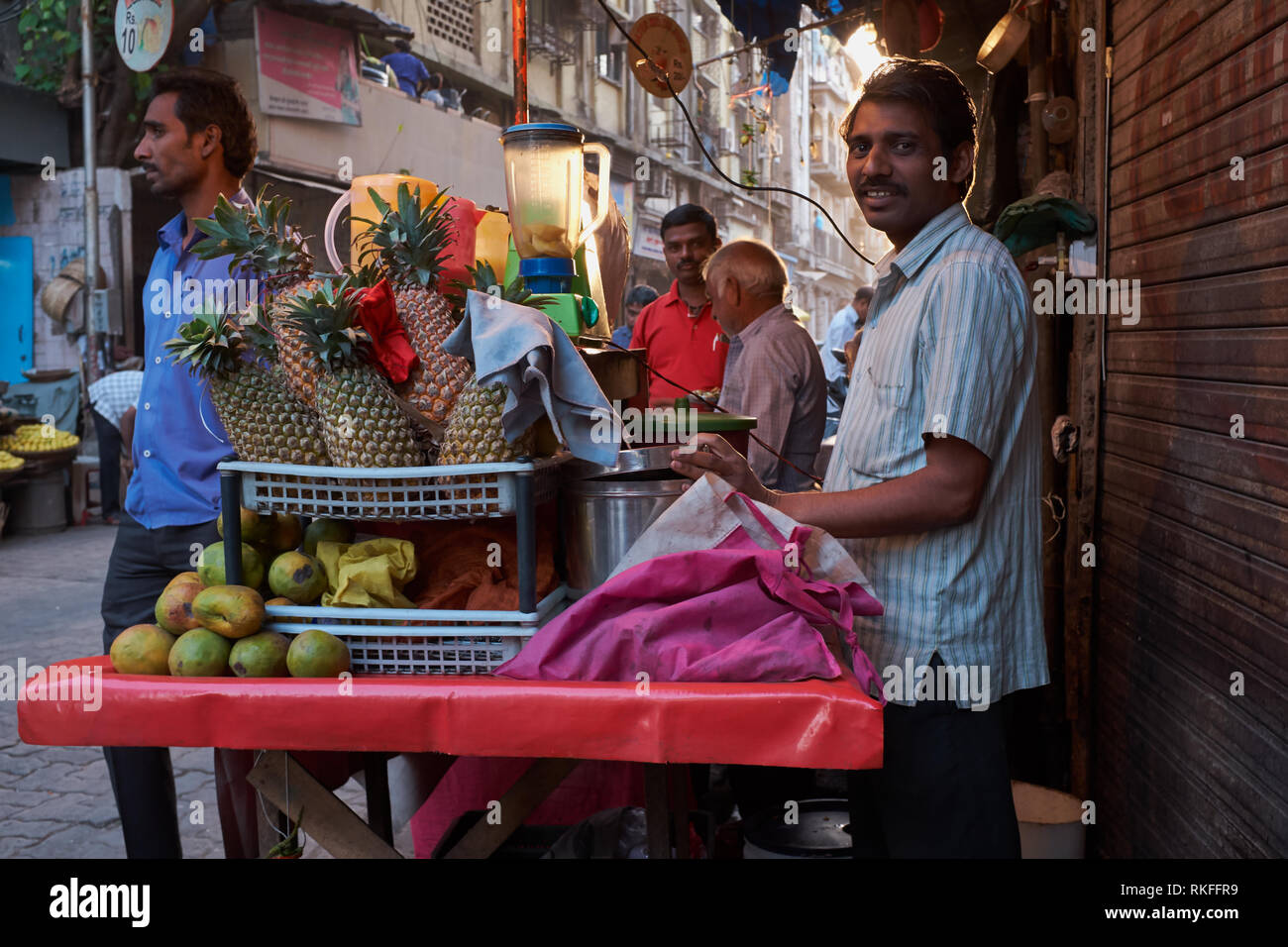 A fruit juice vendor during sunset time in Kalbadevi Road. business