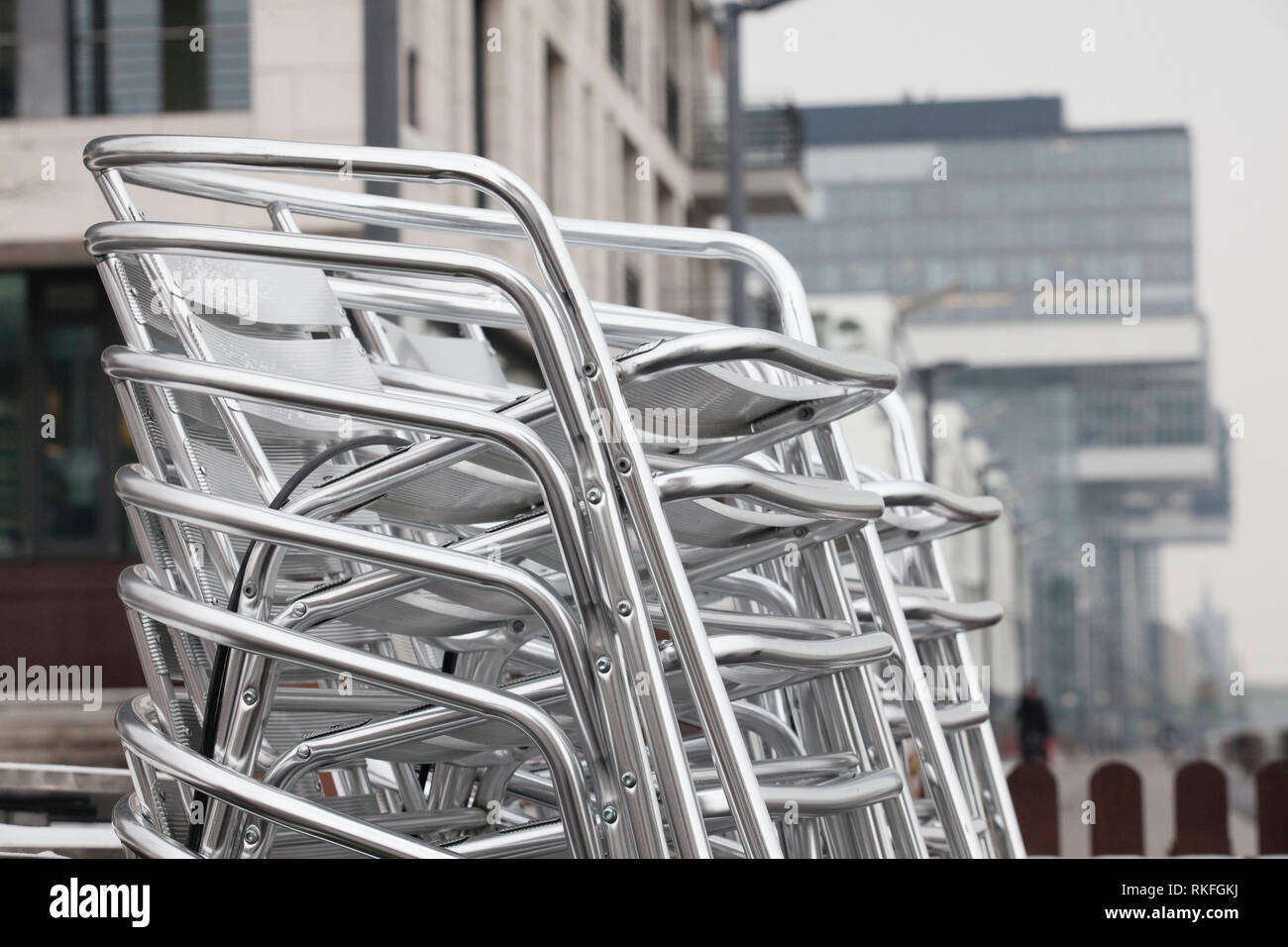 stacked aluminium garden chairs in the Rheinau harbor, Cologne, Germany.  gestapelte Aluminium-Gartenstuehle im Rheinauhafen, Koeln, Deutschland  Stock Photo - Alamy