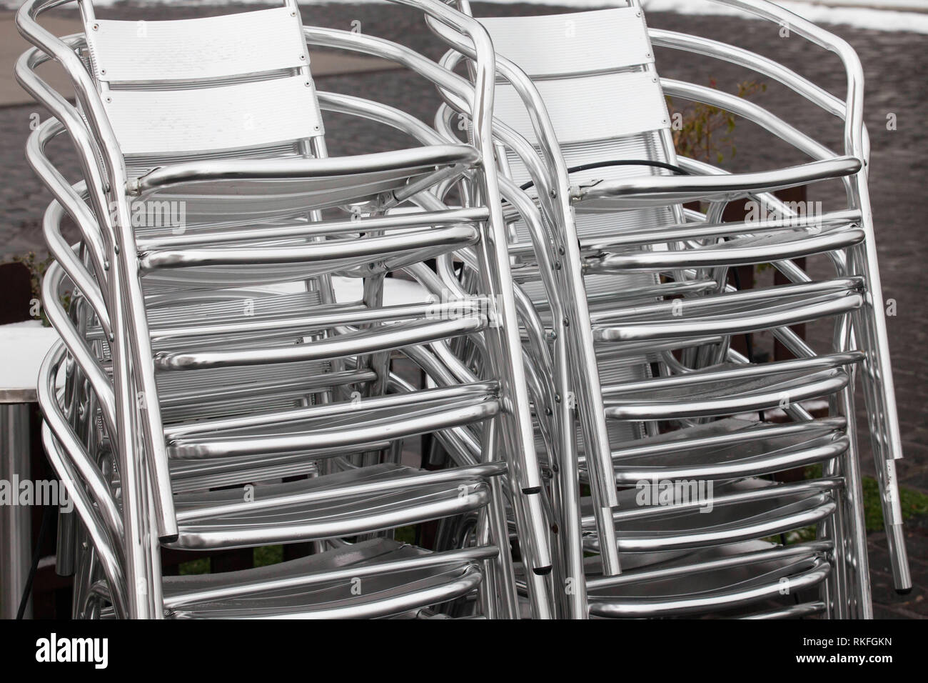 stacked aluminium garden chairs in the Rheinau harbor, Cologne, Germany.  gestapelte Aluminium-Gartenstuehle im Rheinauhafen, Koeln, Deutschland. Stock Photo