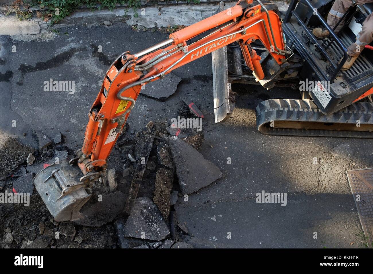 Road workers tear up old asphalt in preparation for repaving - a small street. Pezenas, France Stock Photo