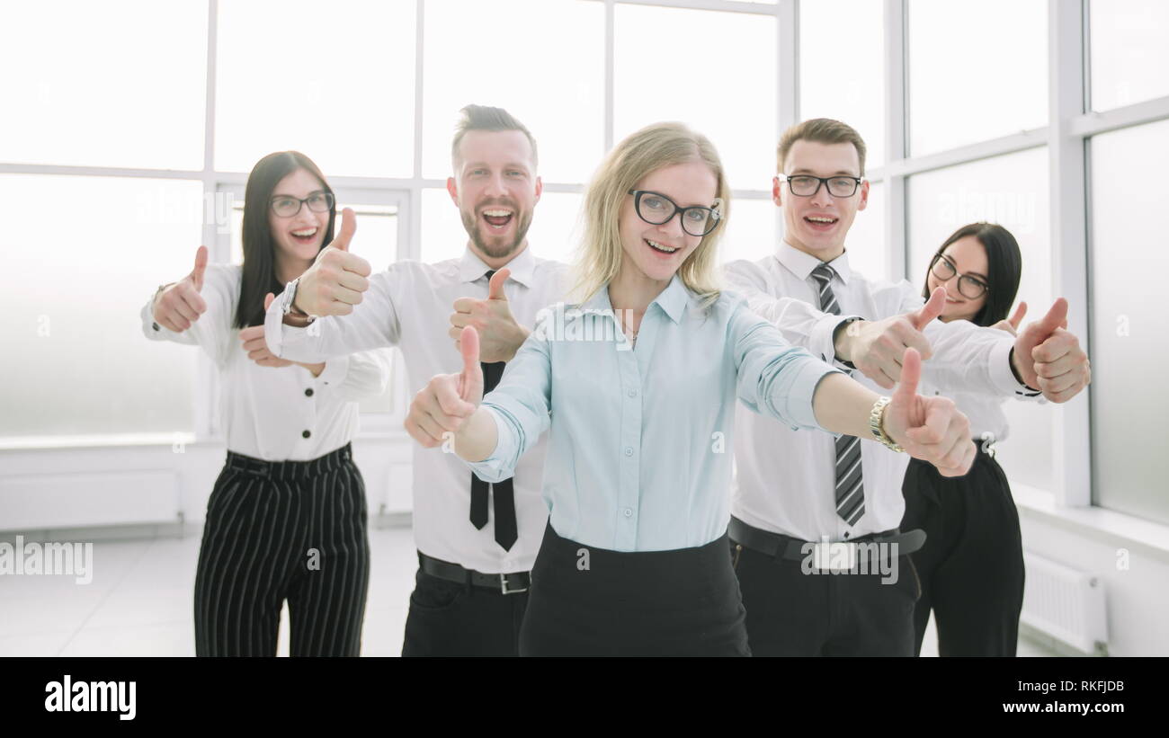 happy business team showing their thumbs up Stock Photo - Alamy