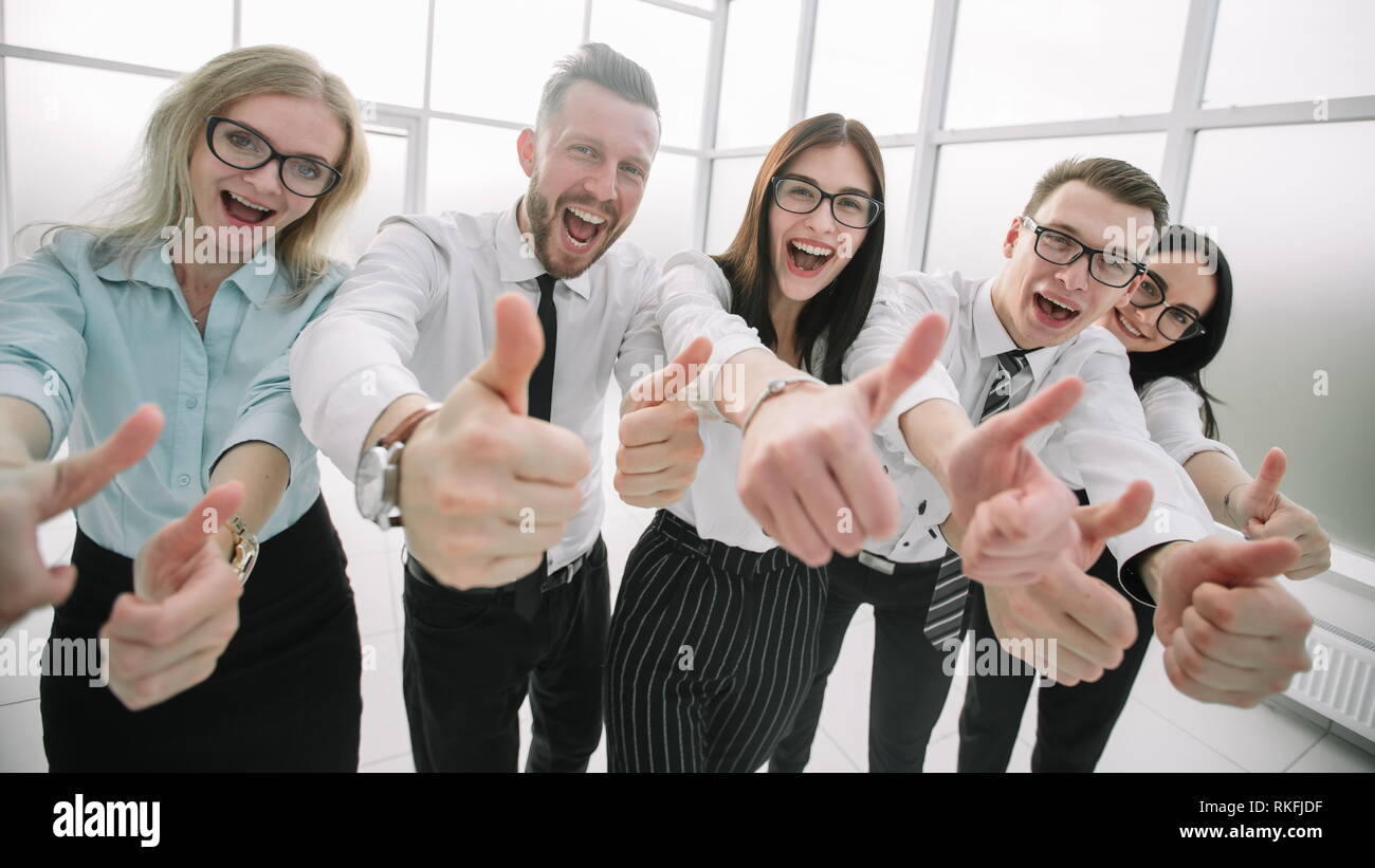 close up. business team showing their thumbs up Stock Photo - Alamy