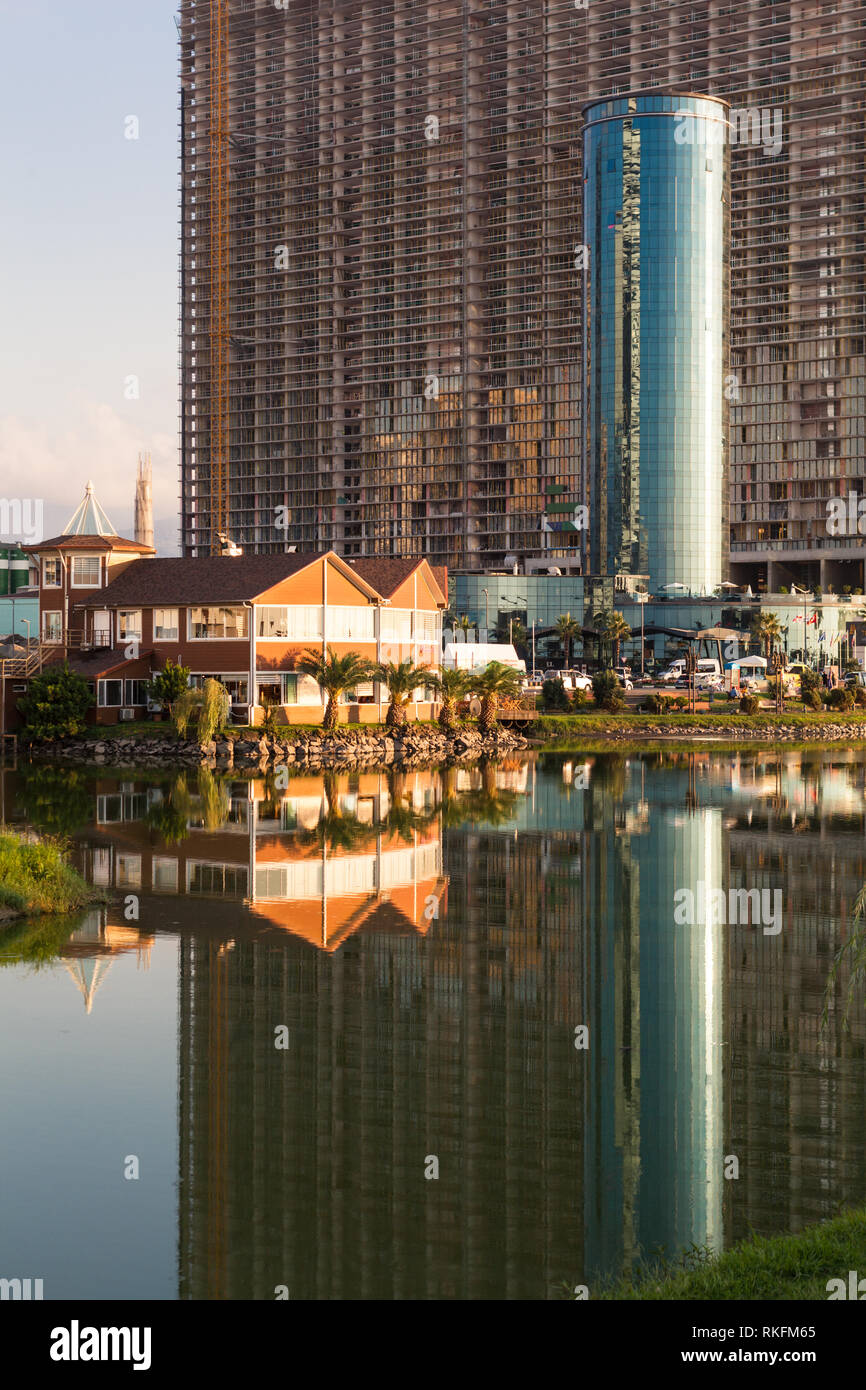 Batumi,Adjara,Georgia - August 26,2018 View on the new modern under construction buildings near Ardagani lake with mirror reflection. Stock Photo