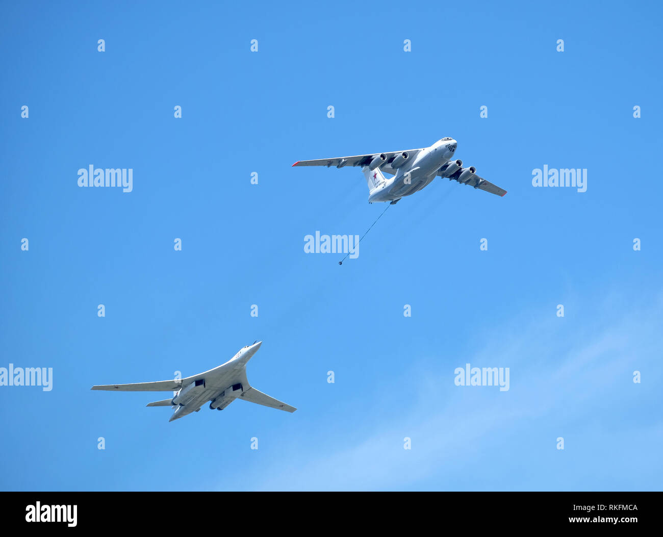 Russian military transport plane Il-78 refueling tankers imitates refueling the Supersonic bomber-missile carrier TU-160 Whire Swan in flight against Stock Photo