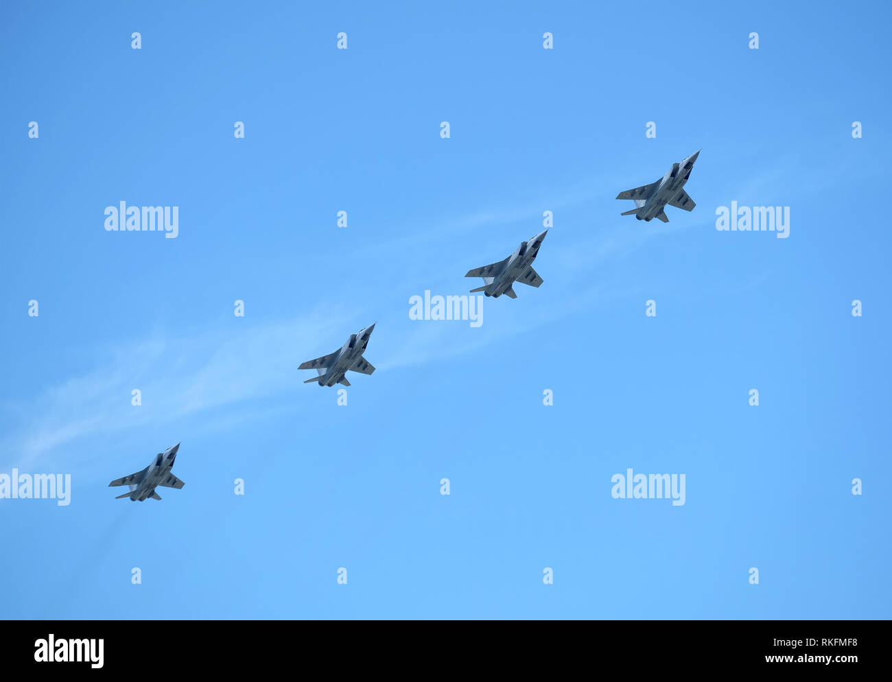 Group of Russian military supersonic high-altitude all-weather long-range interceptor MIG-31 (Foxhound) in flight in the blue sky on parade Stock Photo