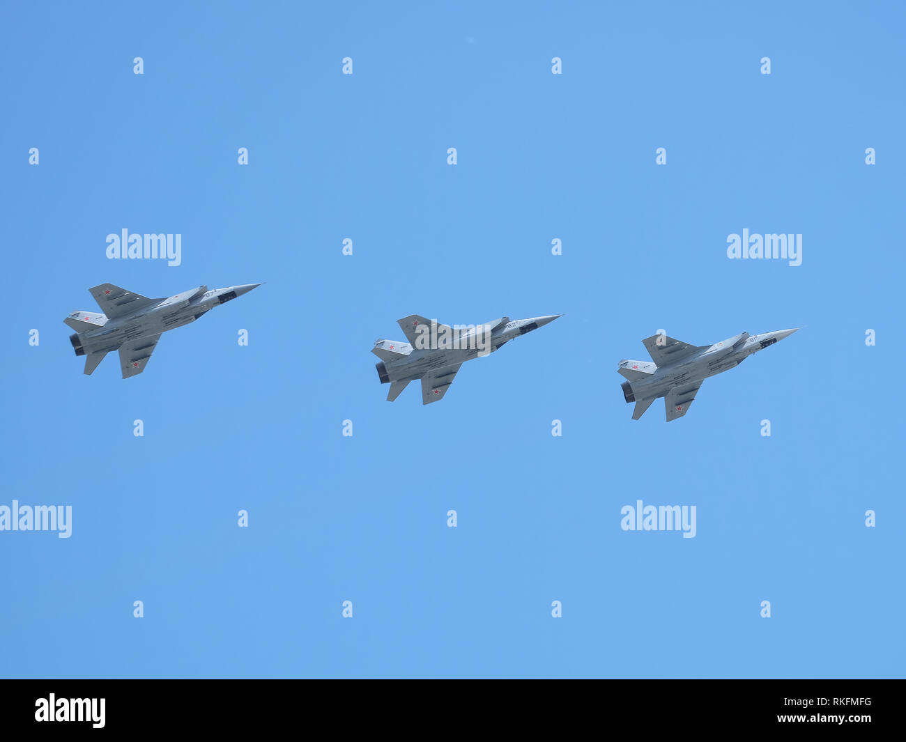 Group of Russian military supersonic high-altitude all-weather long-range interceptor MIG-31 (Foxhound) in flight in the blue sky on parade Stock Photo