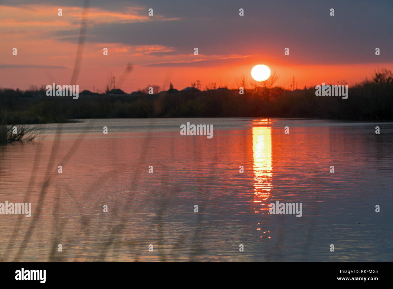 Sunset or sunrise on the cloudy sky on lake Stock Photo - Alamy