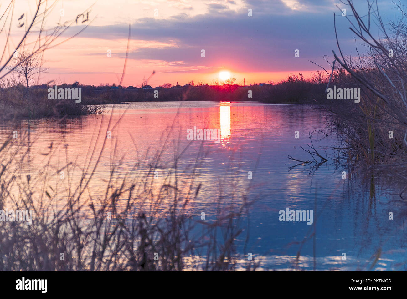 Sunset or sunrise on the cloudy sky on lake Stock Photo - Alamy