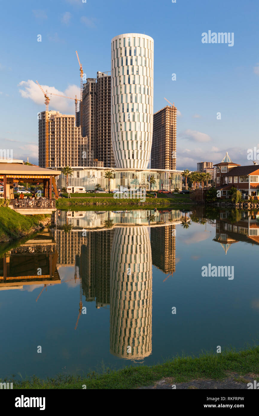 Batumi,Adjara,Georgia - August 26,2018 View on the new modern House of Justice and under construction buildings, Ardagani lake with mirror reflection. Stock Photo