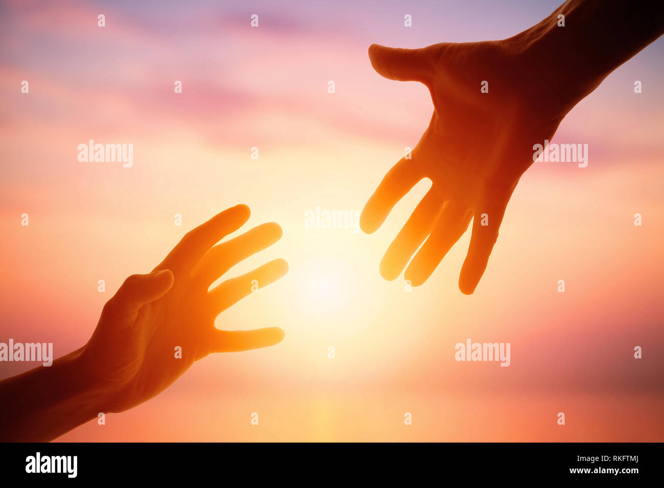 Giving a helping hand on the background of the dawn Stock Photo