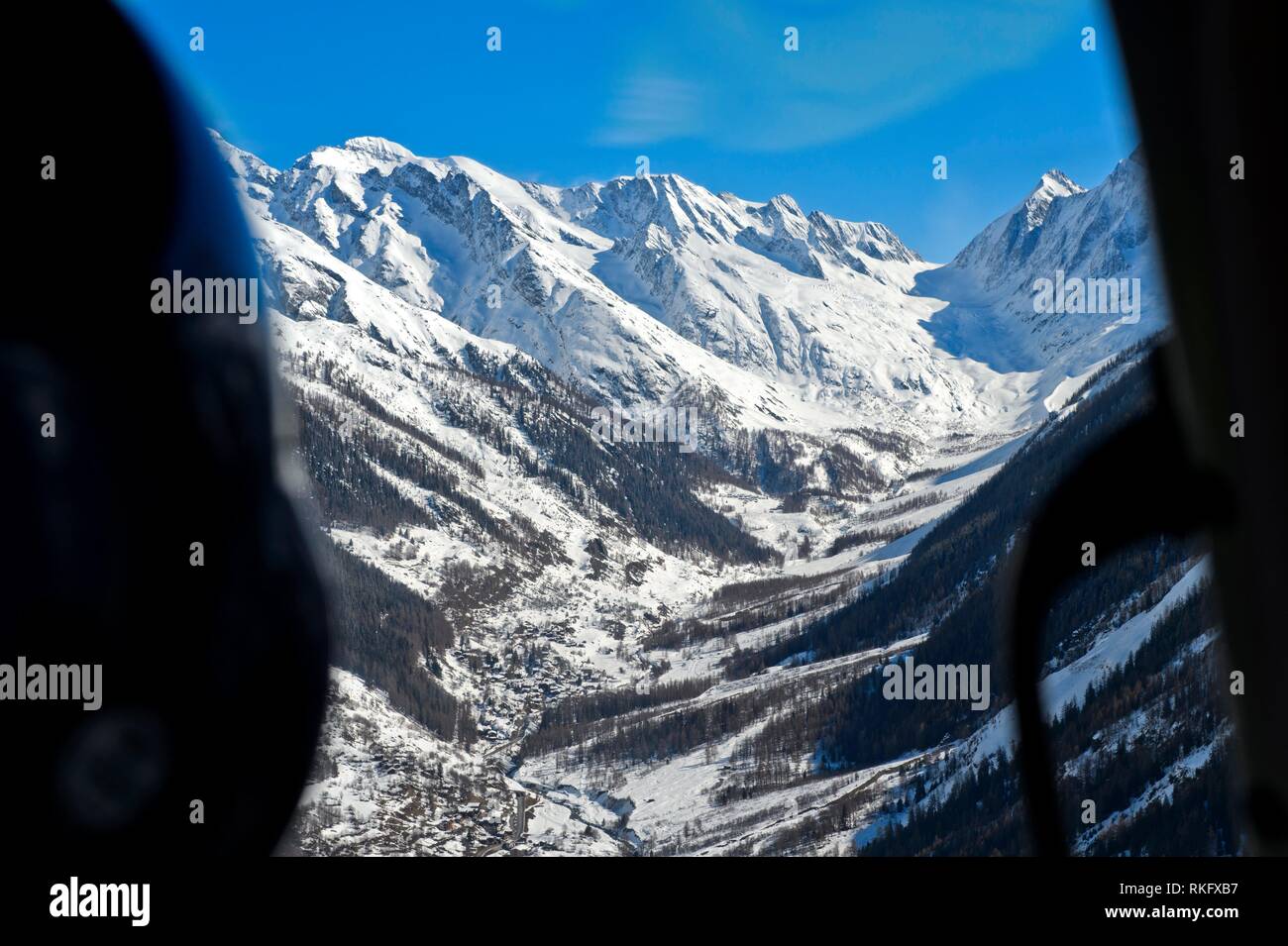 Bird's eye view from a helicopter across the Loetschnetal Valley to the snow-covered peaks of the Bernese Alps, Loetschental, Valais, Switzerland. Stock Photo