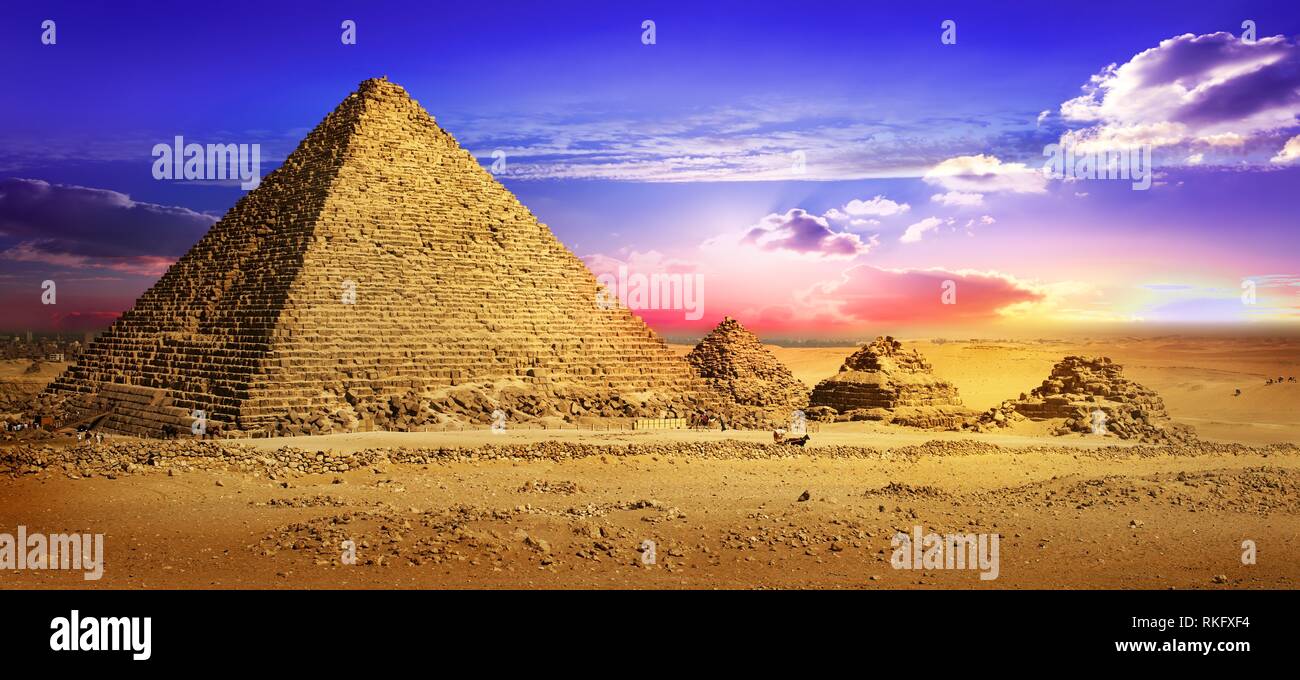 Pyramids in desert under ultra violet clouds. Stock Photo