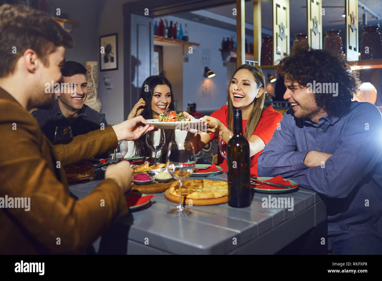 Friends eating at a dinner at a meeting in a restaurant. Stock Photo