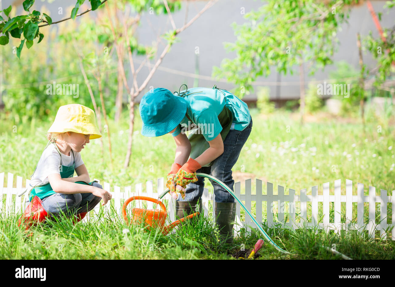 Girl and boy watering plants hi-res stock photography and images - Alamy