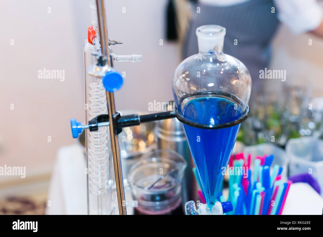 chemical vessel with a blue liquid close-up. glowing drinks of the fluorescent bar, colorful molecular cocktails. physical and chemical laboratory. Stock Photo