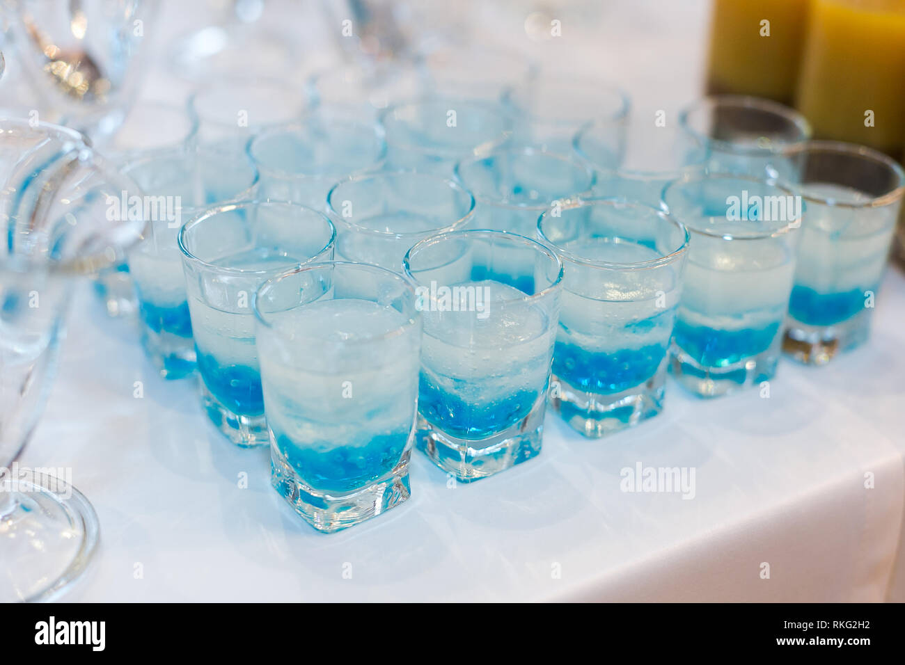 glowing drinks of the fluorescent bar, colorful cocktails with molecular caviar from blue syrups, delicate emulsions and gels of strong men's drinks. Stock Photo
