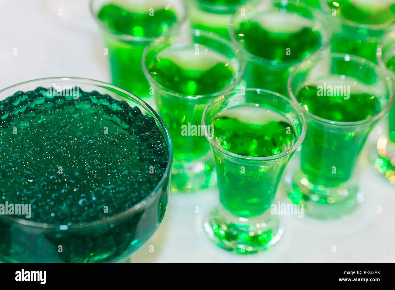vivid green cocktails with molecular caviar close up, glowing drinks of the fluorescent bar. molecular cuisine. Stock Photo