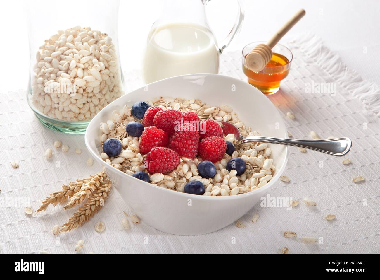 breakfast with milk, oats, puffed rice and red berries. Stock Photo