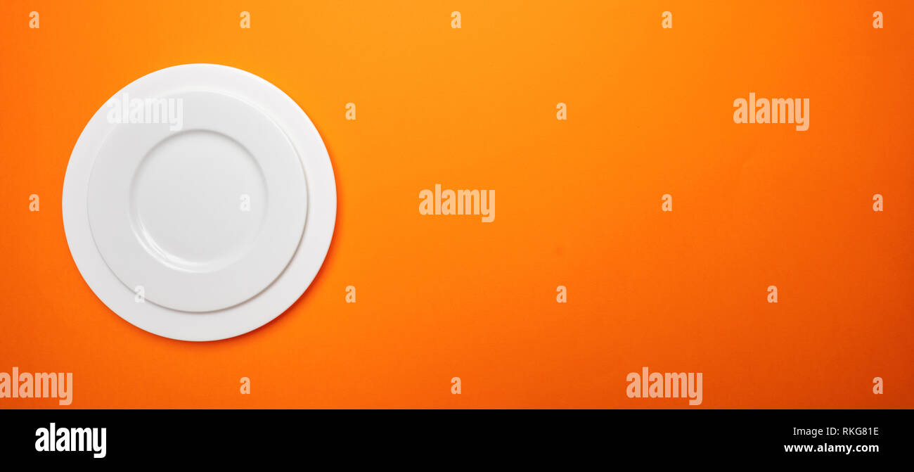 Set Of Empty White Plates On Orange Color Background Banner Top