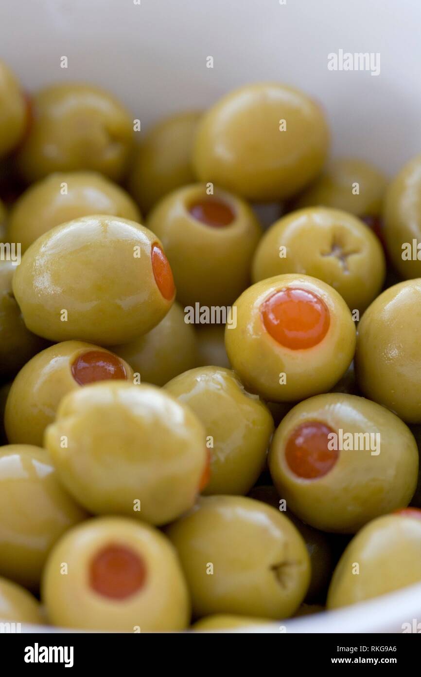 Pimento stuffed green olives in a white bowl Stock Photo Alamy