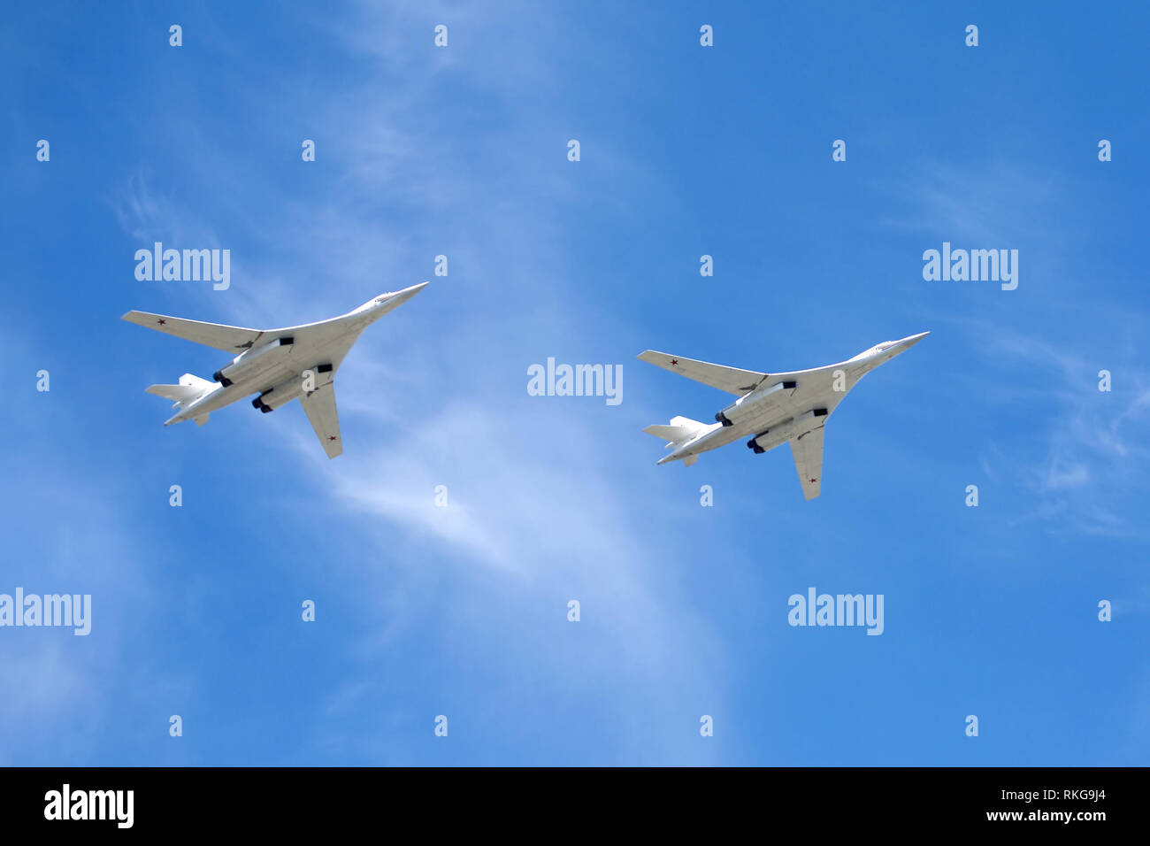 MOSCOW - MAY 9: White Swans. Two Russian military aircrafts supersonic bombers with variable sweep wing Tu-160 on parade, flight against blue sky on M Stock Photo
