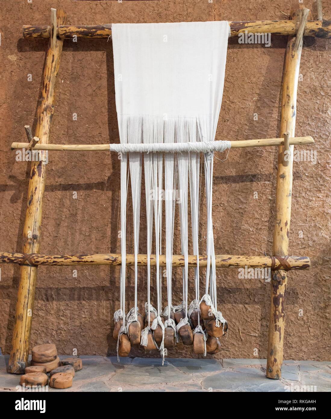 Reconstructed prehistoric age weaving loom. Mudwall ancient house replica. Stock Photo