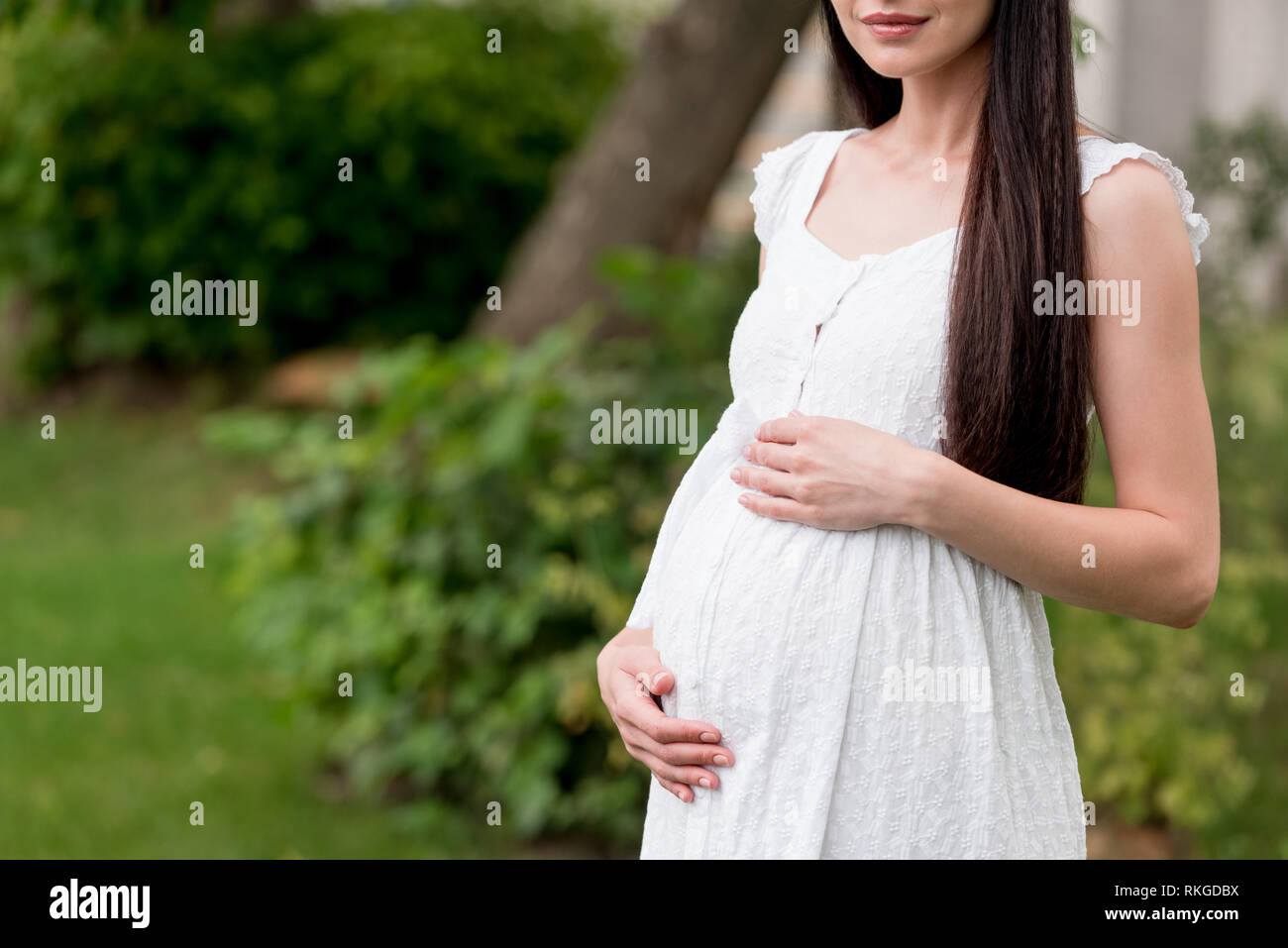 Pregnant girl in white dress hi-res stock photography and images - Alamy