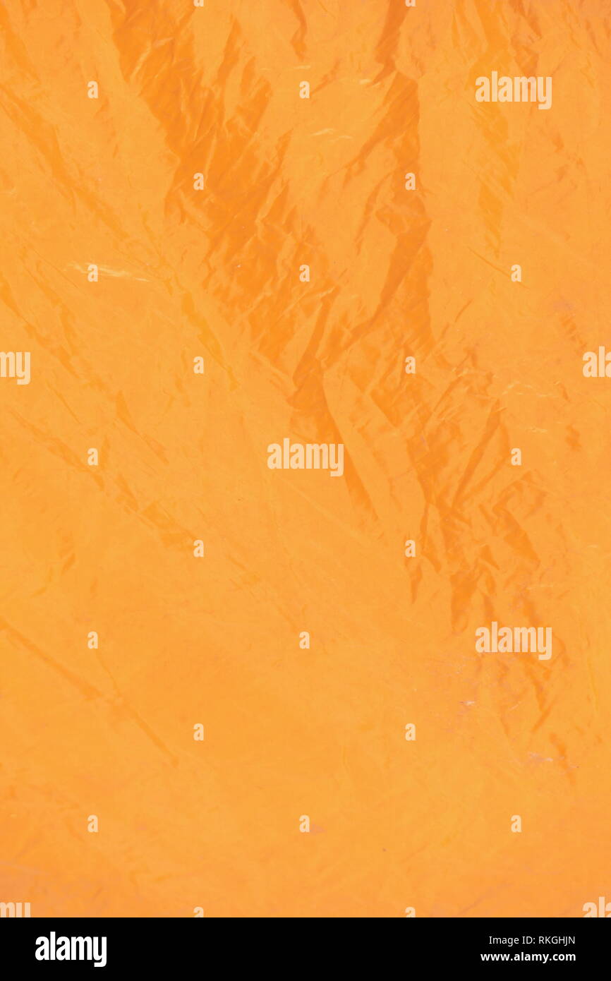 Orange tarpaulin, background picture Stock Photo - Alamy