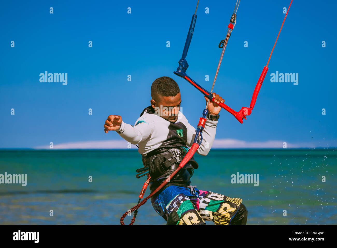 Egypt, Hurghada - 30 November, 2017: Close-up surfer holding the kite rope standing on the surfboard. Red sea background. The outdoor activity. Extrem Stock Photo