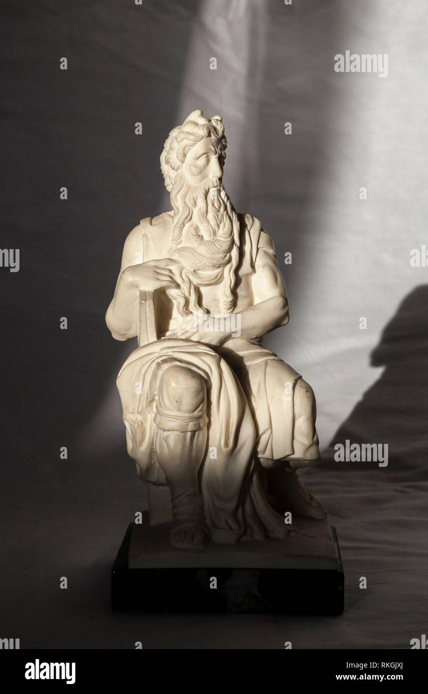 Replica of Michelangelo Moses sculpture, very popular as Rome souvenir. Studio take over wrinkled white fabric. Stock Photo