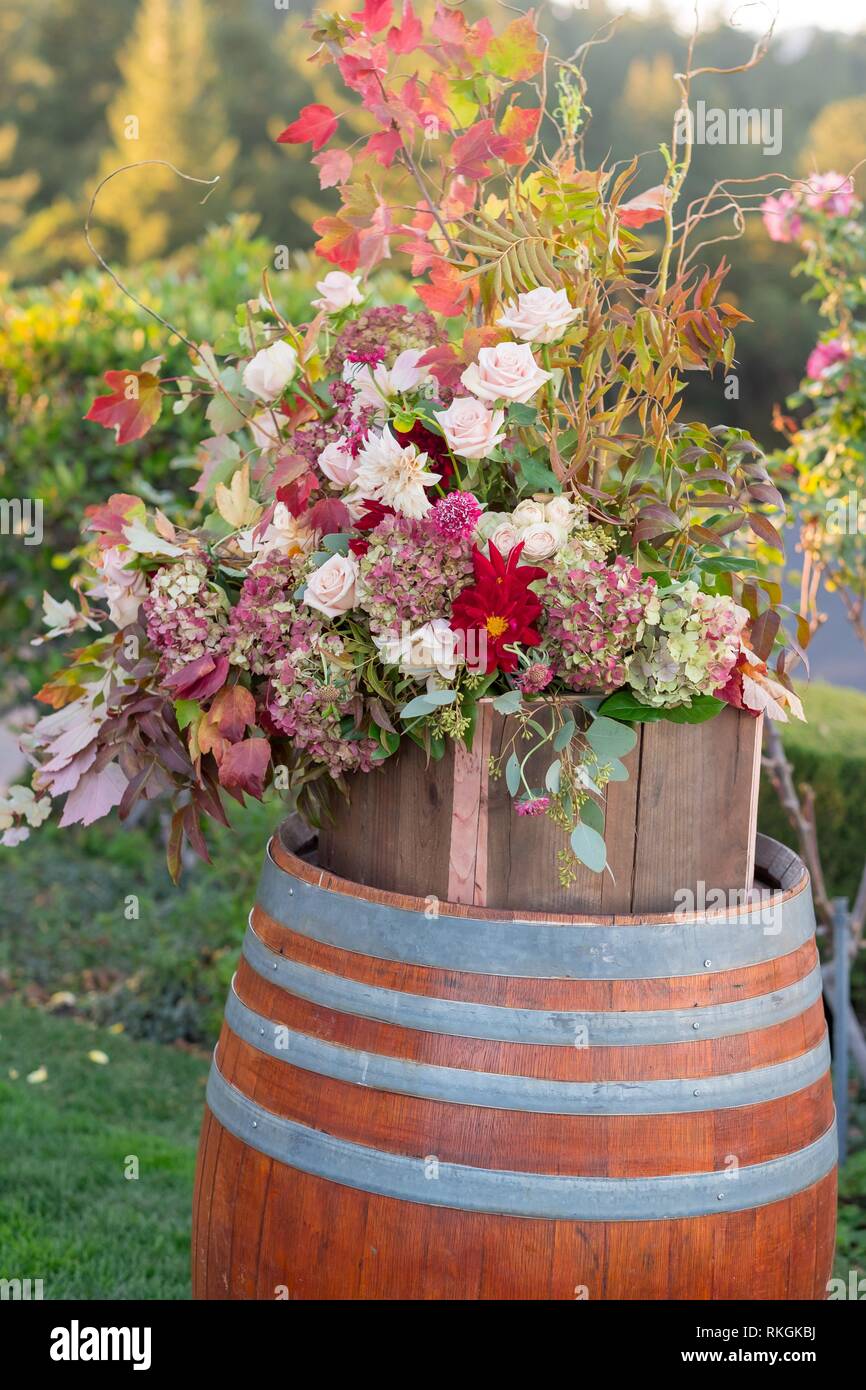 Wedding ceremony with flowers on wine barrels for decor at this