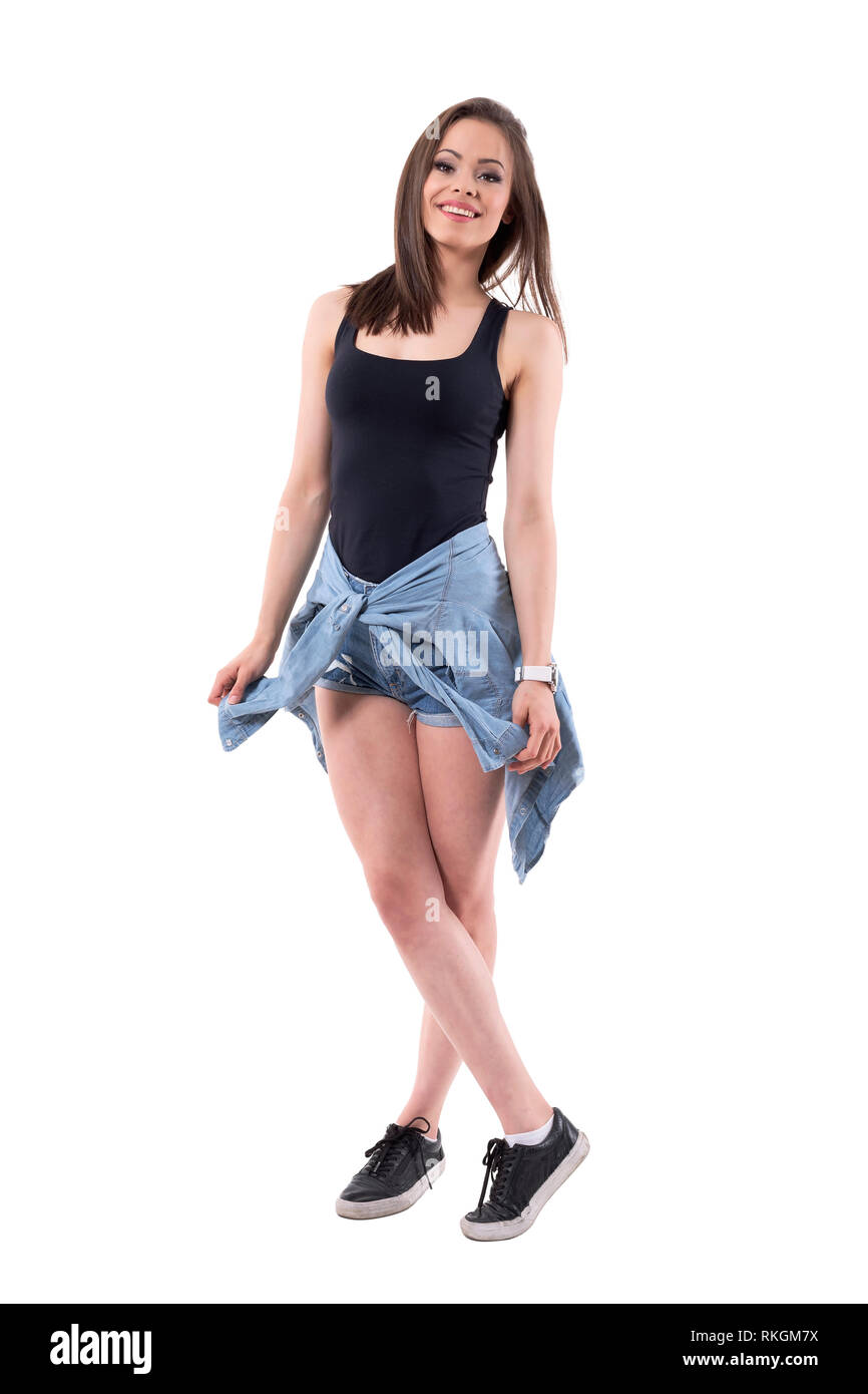 Playful gorgeous young woman in fashionable street style look posing ...