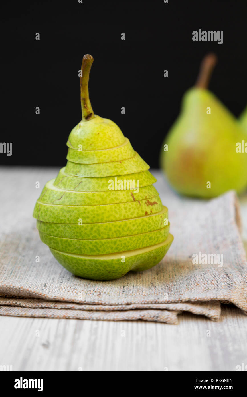 Sliced fresh pear on cloth, close-up. Side view. Stock Photo
