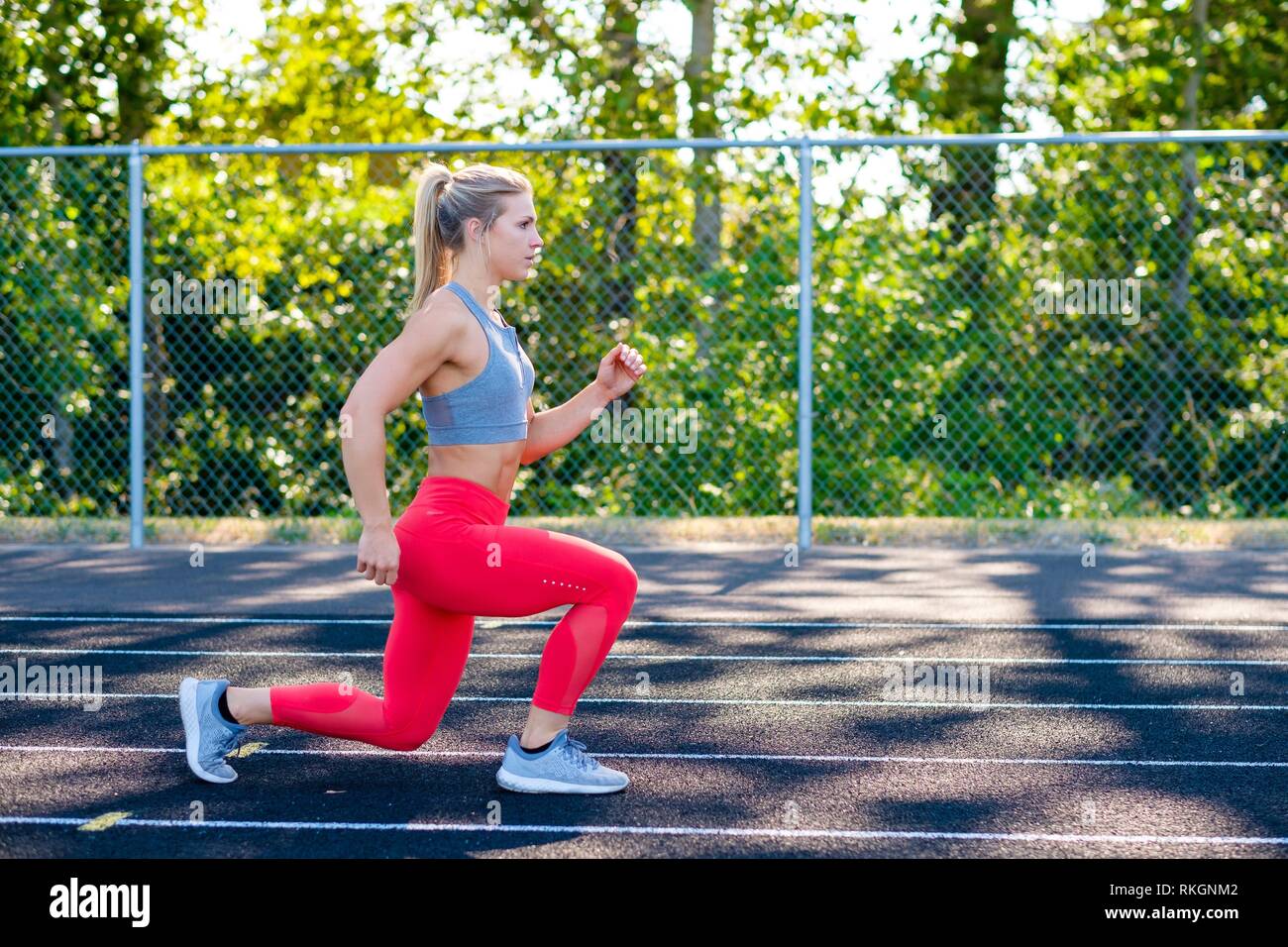 Lunges performed by a young female athlete while working out on an