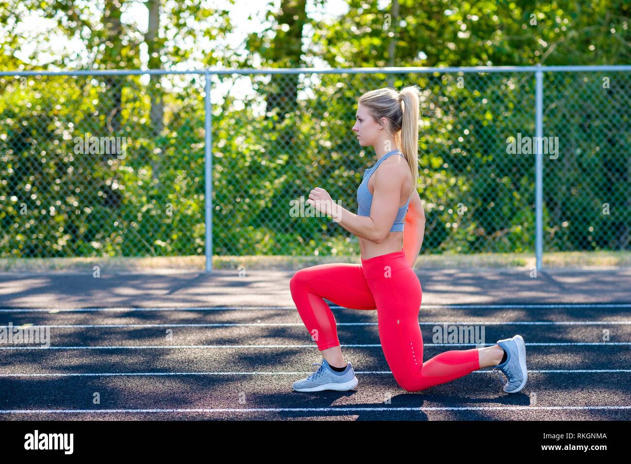 Lunges performed by a young female athlete while working out on an