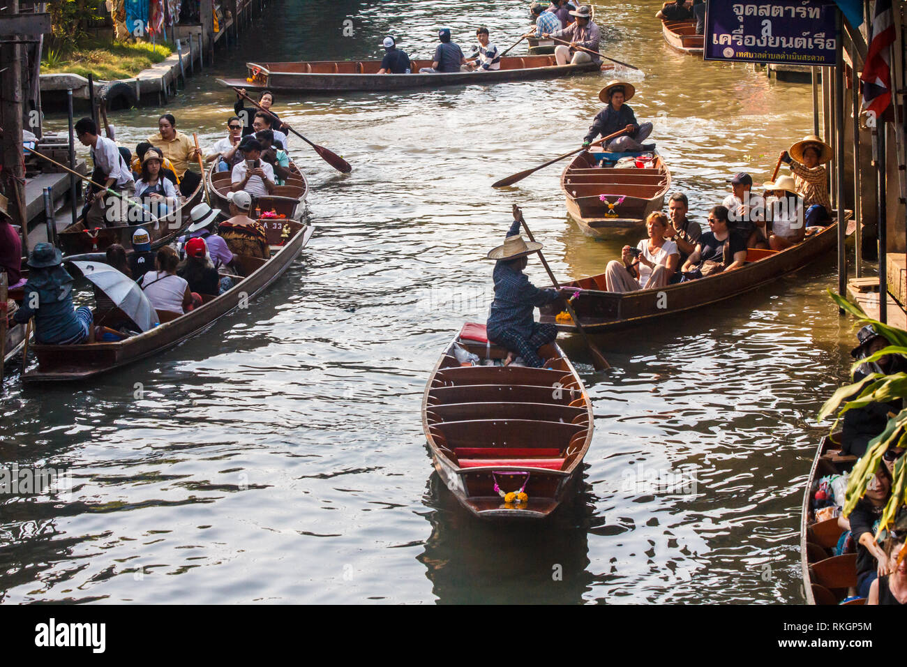 Damnoen Saduak, Thailand - 4th March 2017: Tourists in boats.  The floating market is a popular tourist atrraction Stock Photo