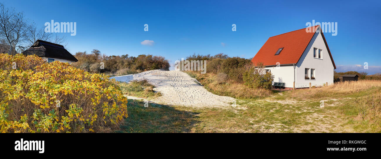 Traditional houses and entrance to the beach, Vitte village on island of Hiddensee, off the Baltic coast of Northern Germany, panoramic image Stock Photo