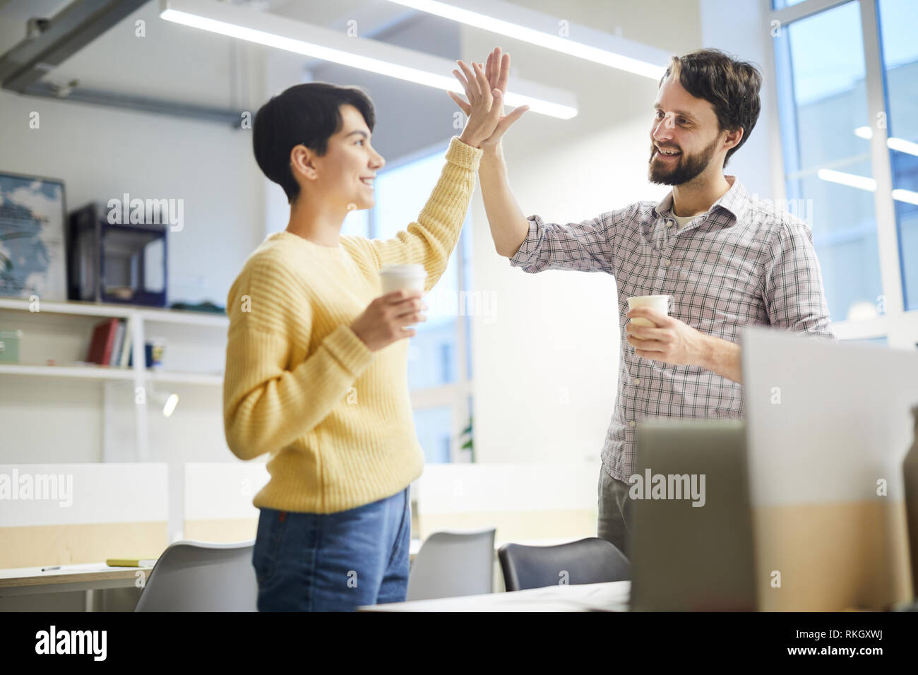 Excited colleagues giving high five Stock Photo