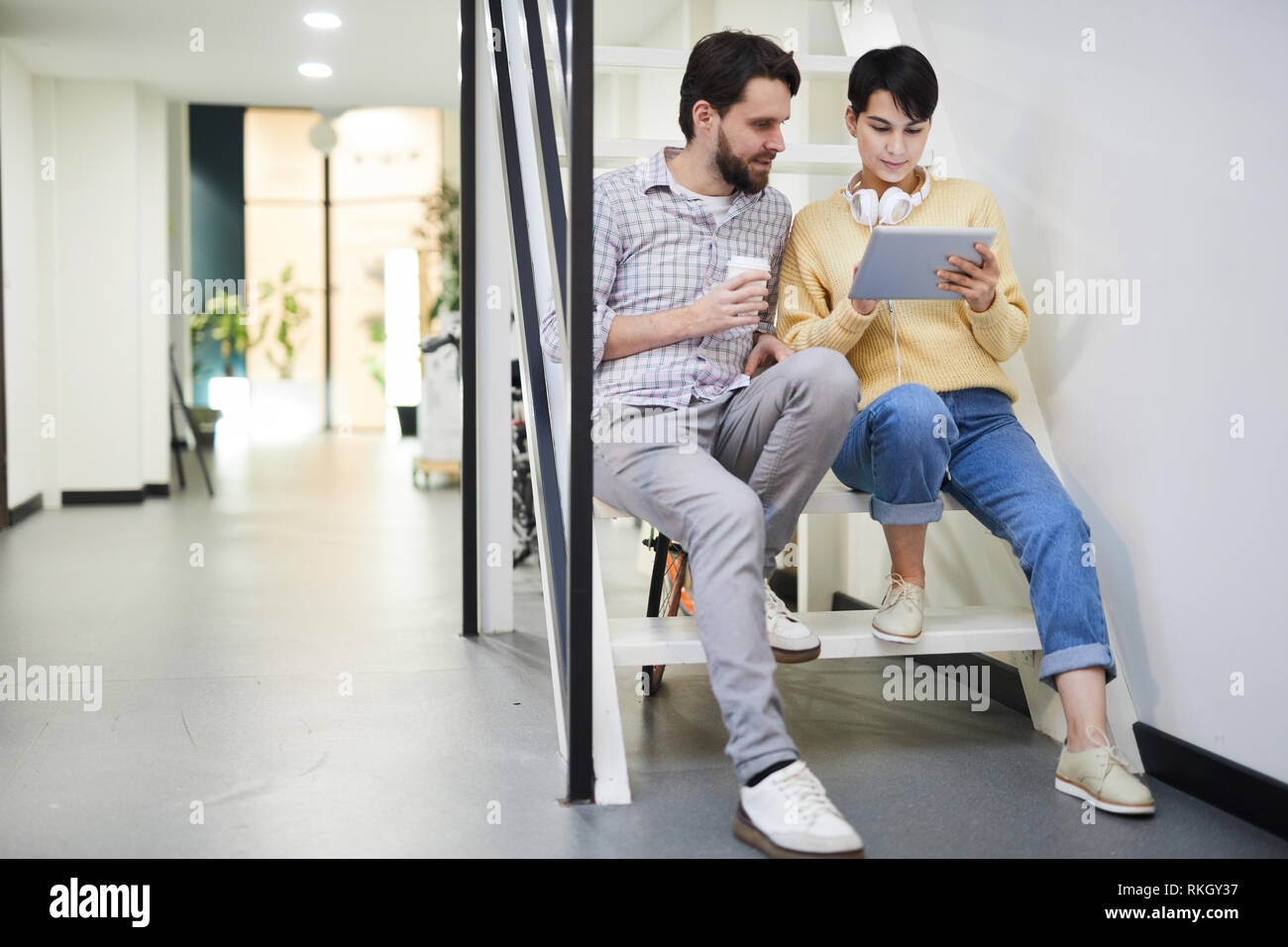 Modern colleagues analyzing online data on tablet Stock Photo