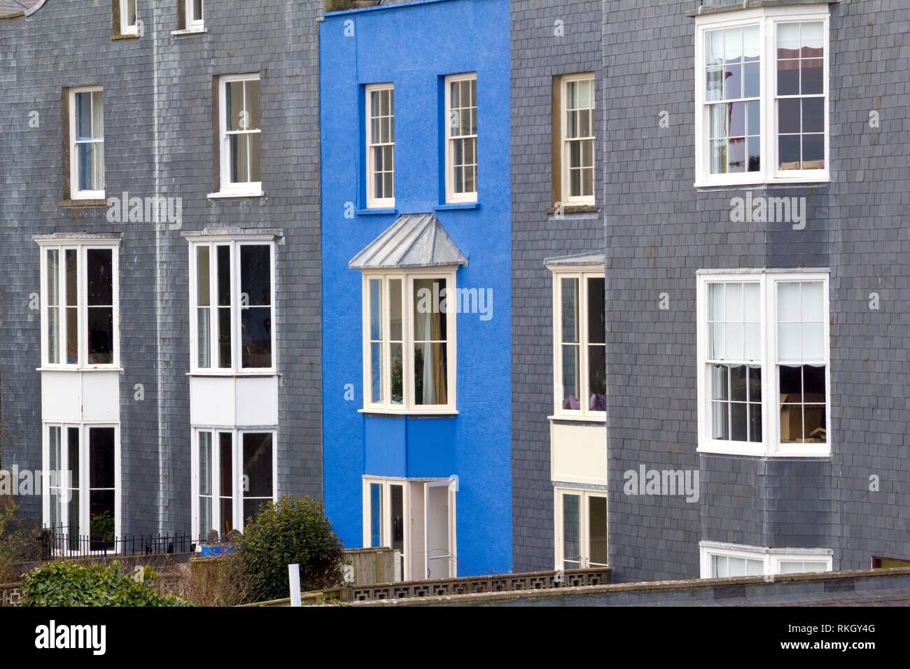 A vibrant blue painted house amongst grey slate at tenby pembrokeshire wales uk