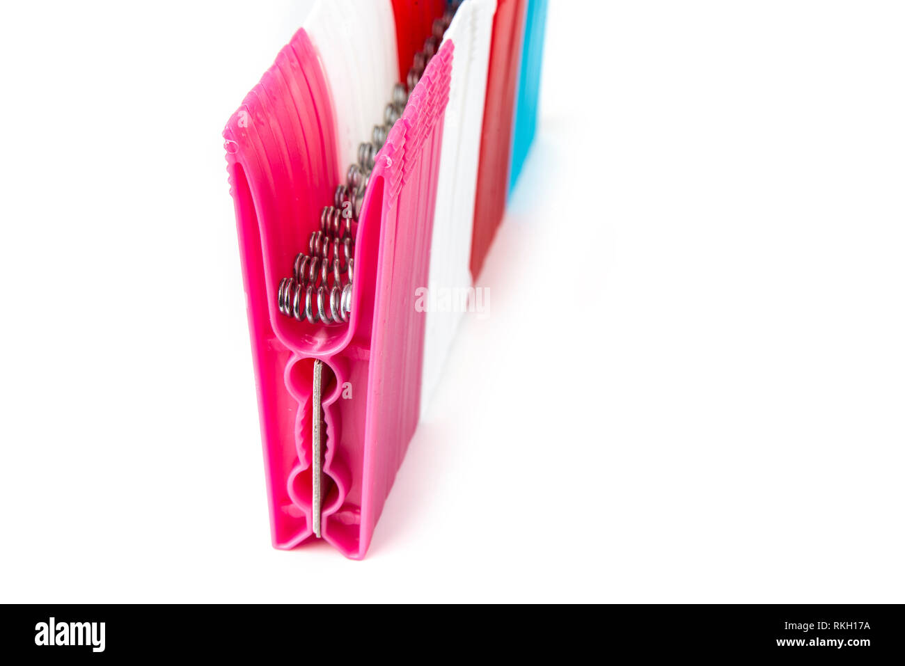 Colorful clothes  pegs made of plastic in  a row Stock Photo