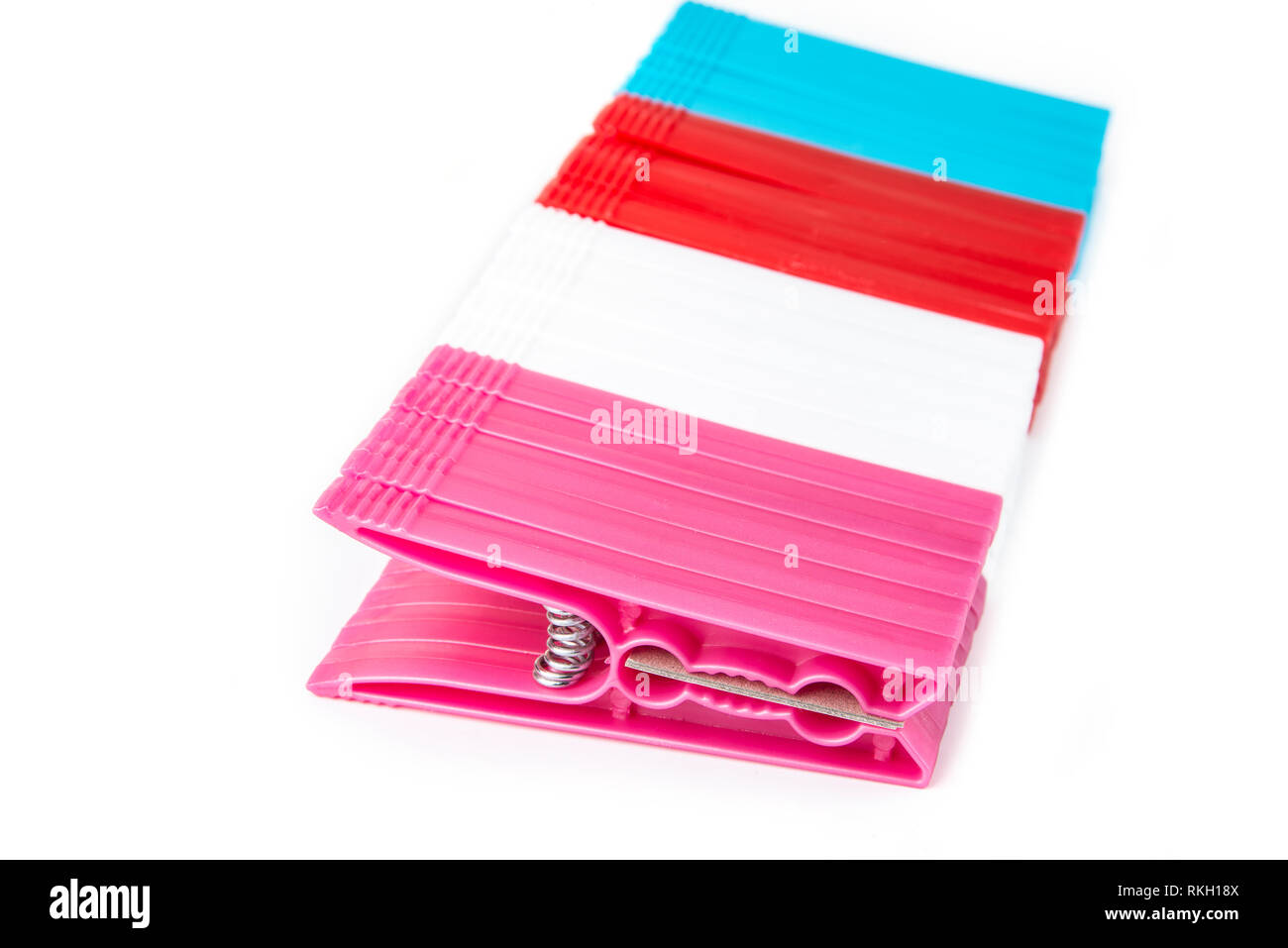 Colorful clothes  pegs made of plastic in  a row Stock Photo