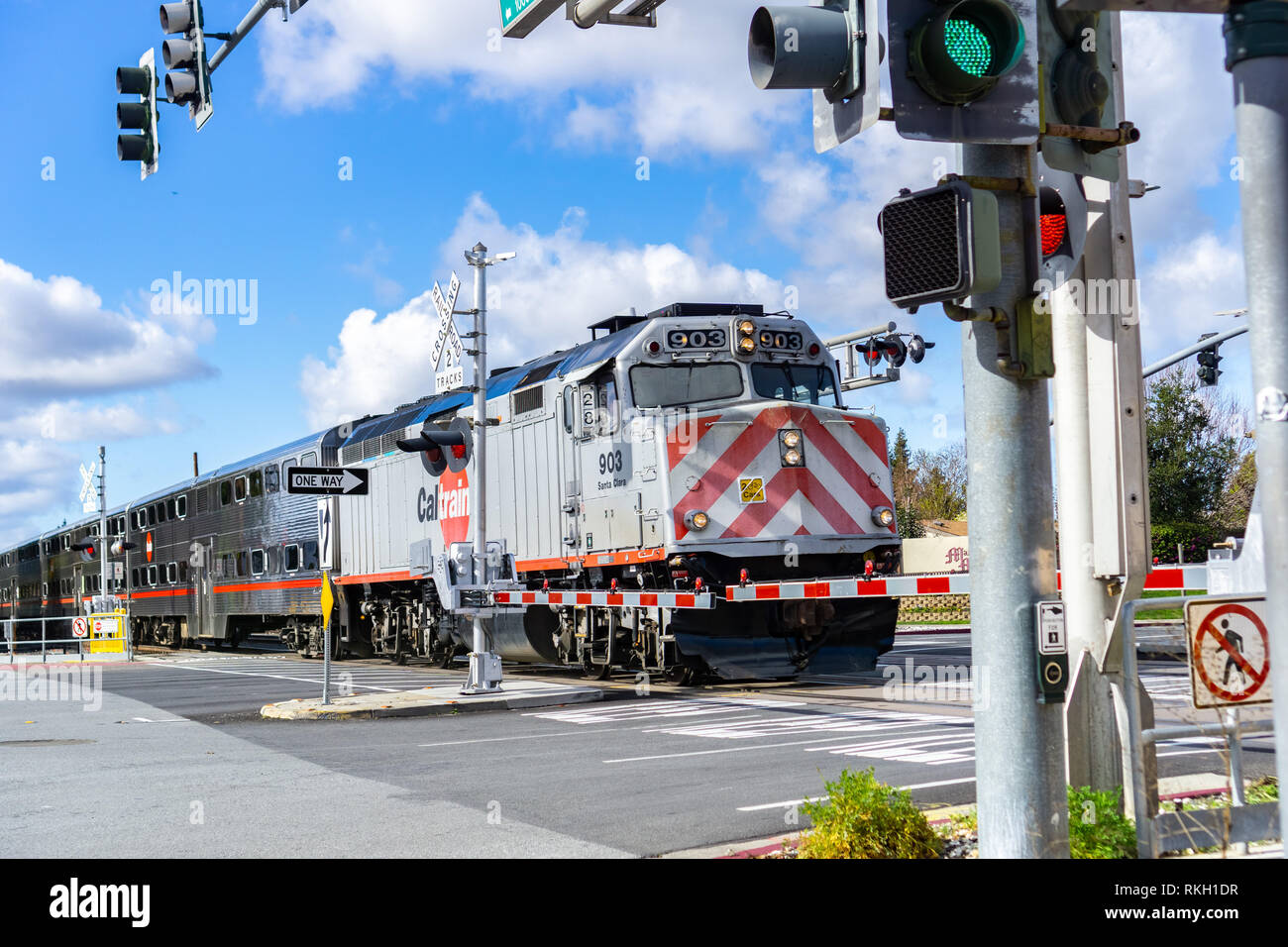 February 10, 2019 Sunnyvale / CA / USA - Caltrain crossing at a street junction near a residential neighborhood in south San Francisco bay Stock Photo