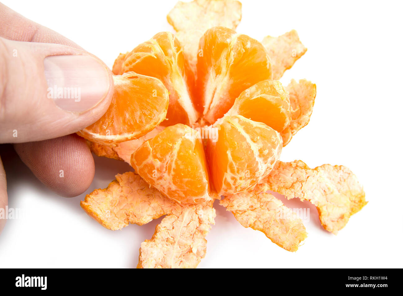 Peel of tangerine by hand on a white background Stock Photo - Alamy