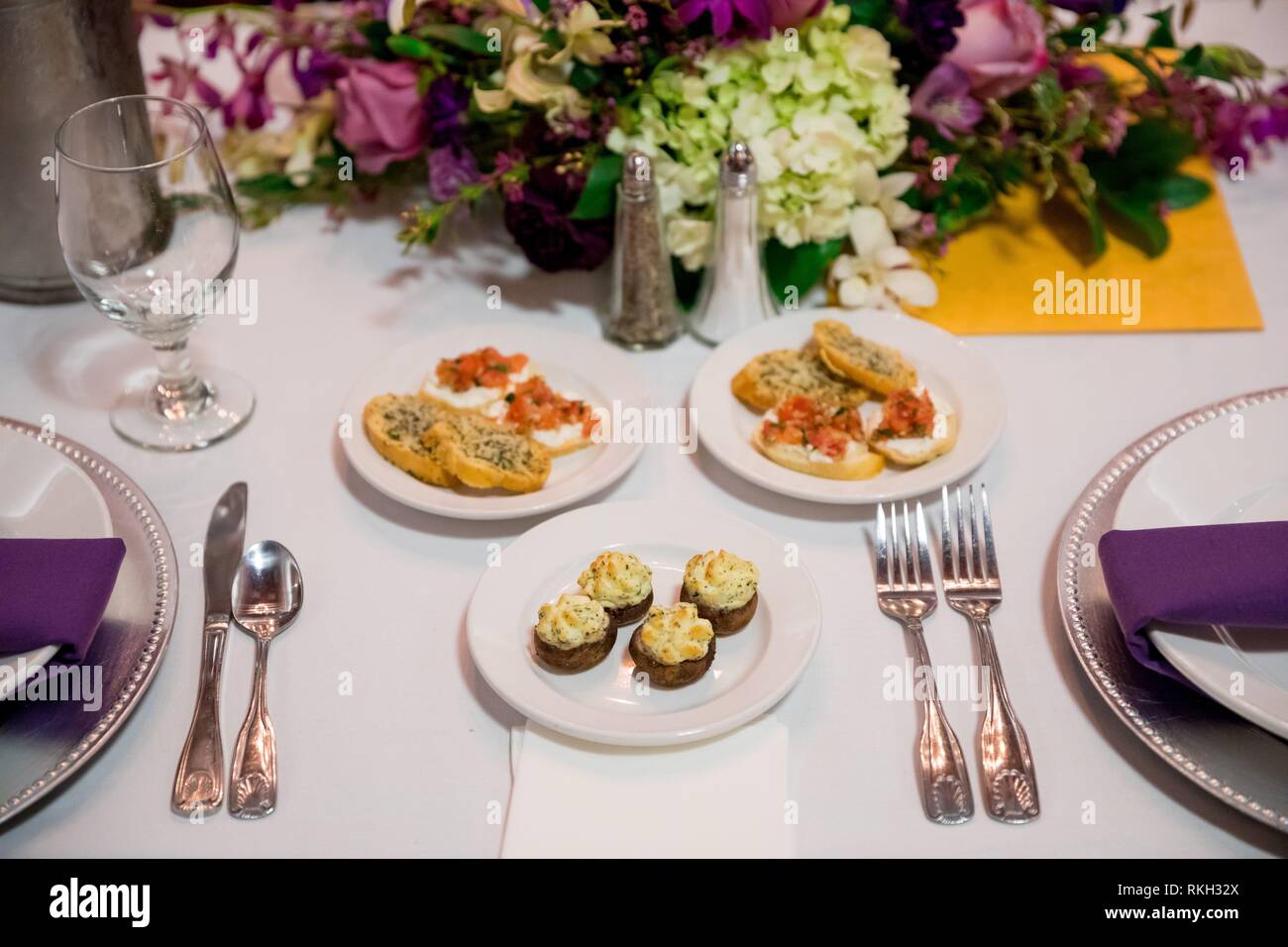 Cocktail Hour Appetizers On Plates At A Table At An Indoor Wedding