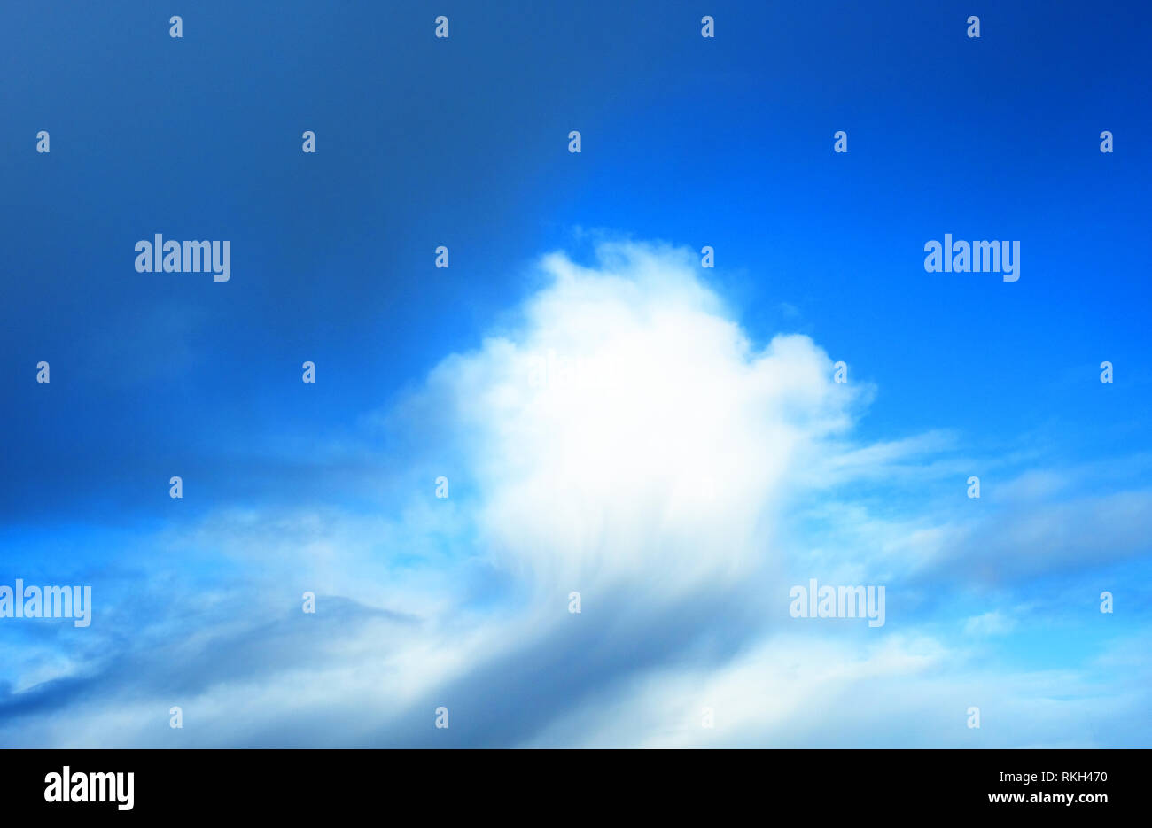 Wintry clouds against a vivid blue sky - John Gollop Stock Photo