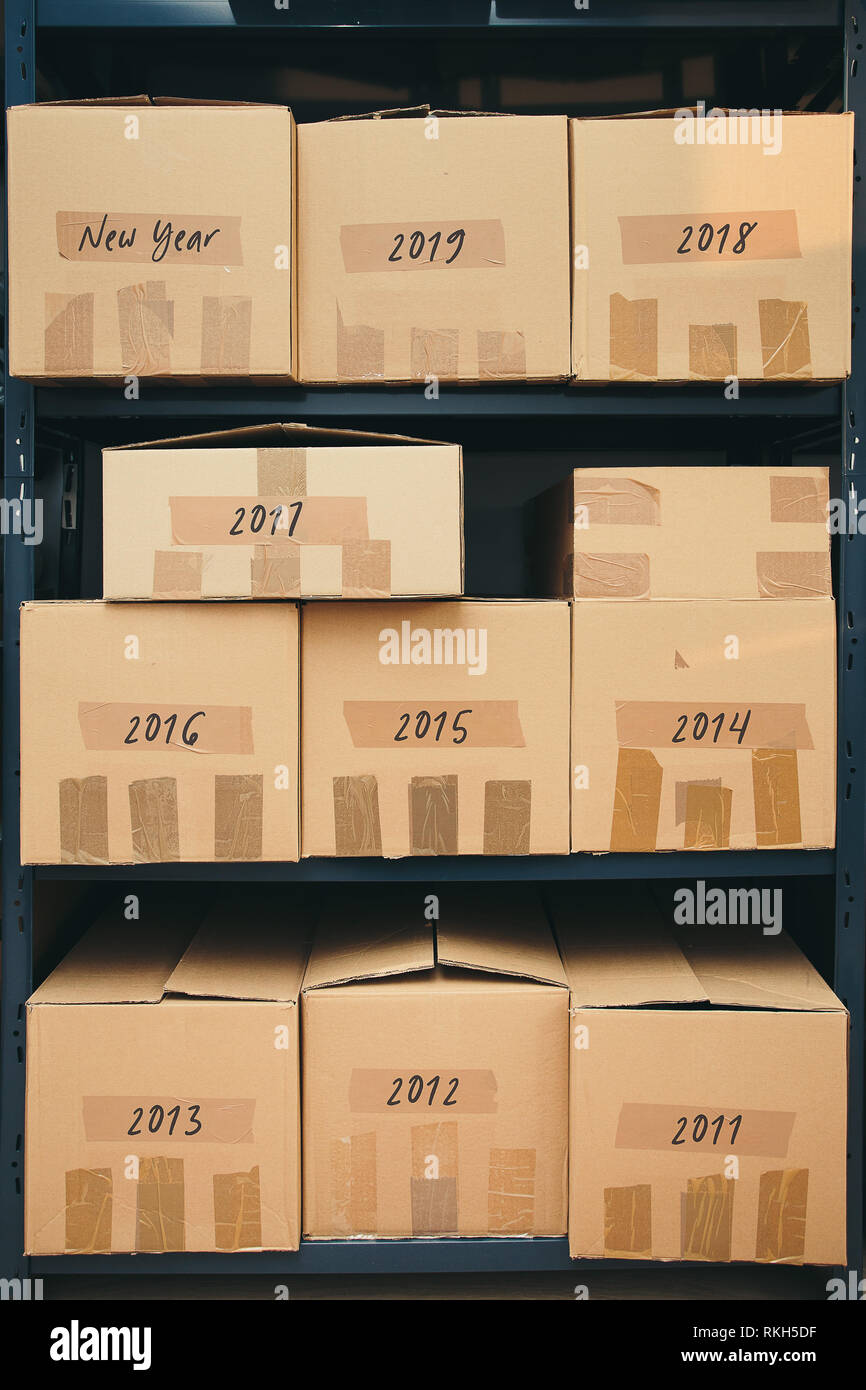 Cardboard boxes labeled number of years on shelves Stock Photo Alamy