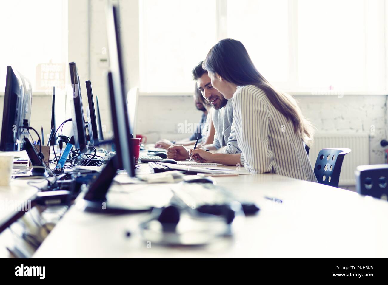 We are waiting for your call. Call center workers are working at modern