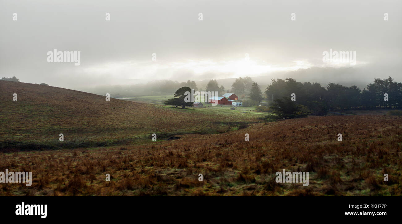 Farm under a cloudy sky Stock Photo - Alamy