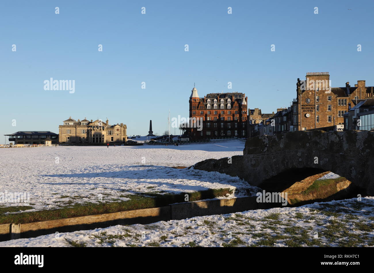 Swilken Bridge and Royal and Ancient Clubhouse with snow St Andrews Fife Scotland   February 2019 Stock Photo